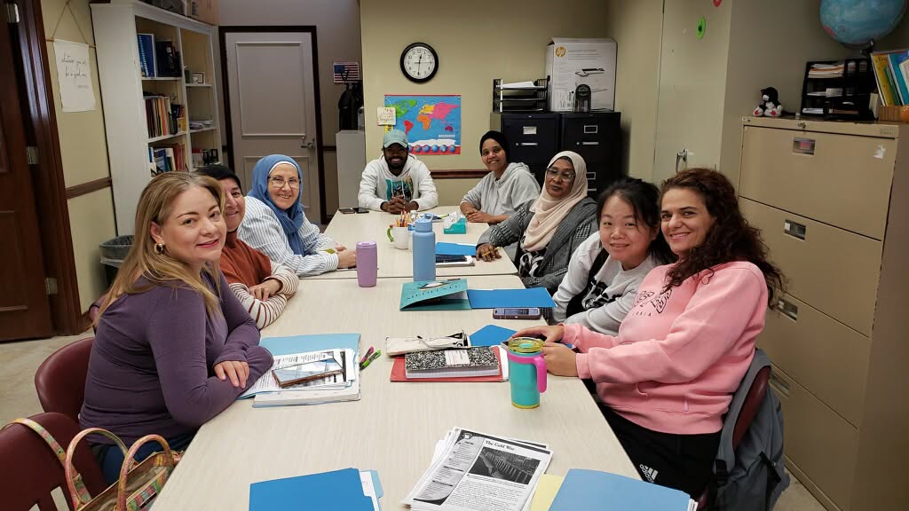 Adult ASPIRE students working together around a classroom table